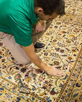 Chem-Dry technician checking area rug before cleaning